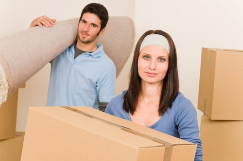 Careful loading of bulky household furniture into a removal vehicle