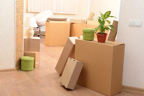 Movers handling desks and filing cabinets in a local commercial property