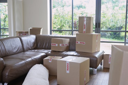 Professional movers handling furniture in a Tufnell Park flat with stairs