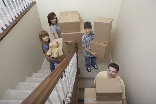 Careful handling of household items on a narrow staircase